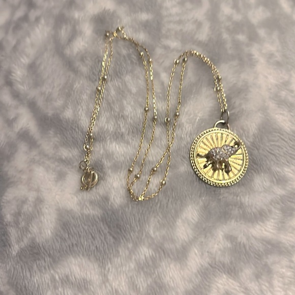 This is a gold elephant necklace with diamonds. - Picture 1 of 4